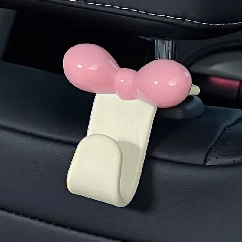 Car Accessories For Road Trip - ミニマリストなボウ型車用後部座席吊り下げフック、実用的な収納アクセサリー、ハンドバッグ、軽食、車内旅行用品用